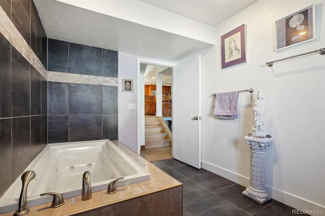 full bathroom with tile patterned flooring, a jetted tub, and baseboards