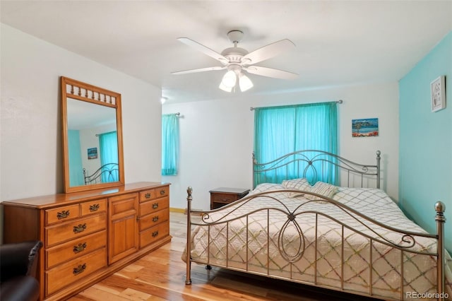 bedroom with ceiling fan and light wood-style flooring