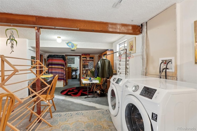 laundry room with laundry area, independent washer and dryer, and a textured ceiling