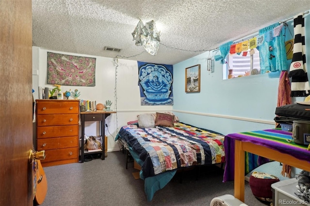 carpeted bedroom with visible vents and a textured ceiling