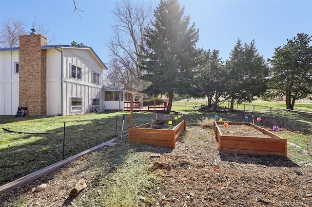 view of yard with fence and a garden