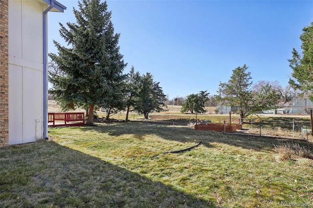 view of yard featuring a vegetable garden and fence