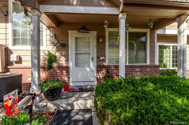 property entrance featuring a porch and central AC