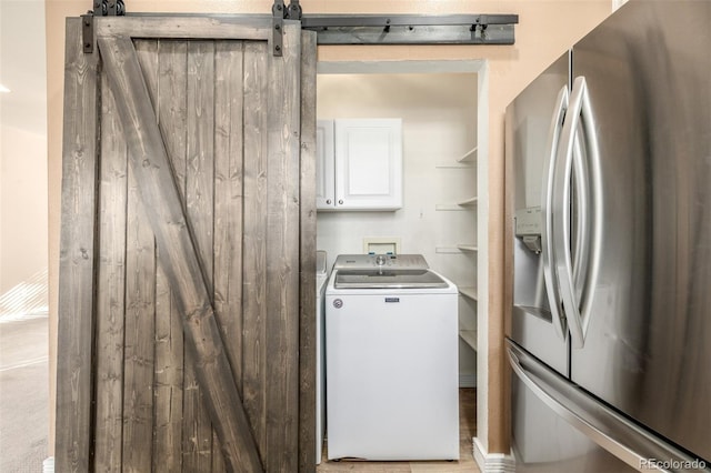 laundry room featuring washer / dryer and a barn door