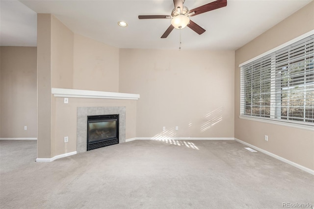 unfurnished living room featuring ceiling fan, a fireplace, and carpet floors