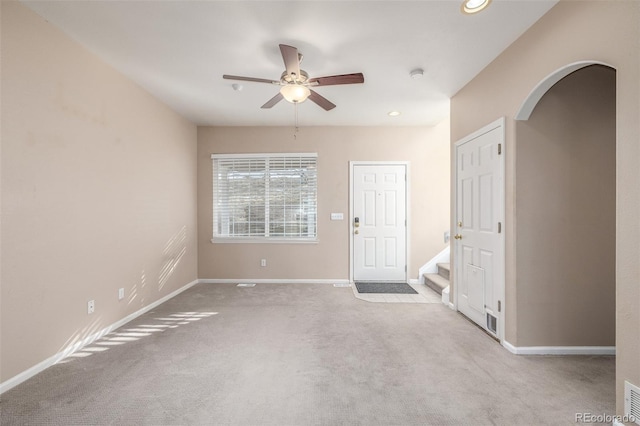 unfurnished room featuring ceiling fan and light carpet