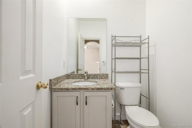 bathroom featuring vanity and toilet