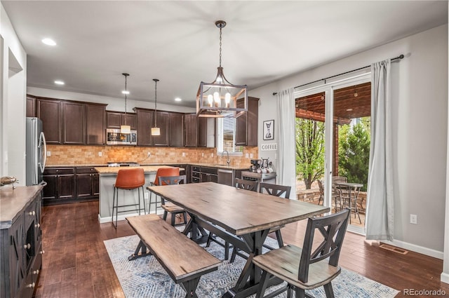 dining room featuring dark wood-type flooring, recessed lighting, baseboards, and visible vents