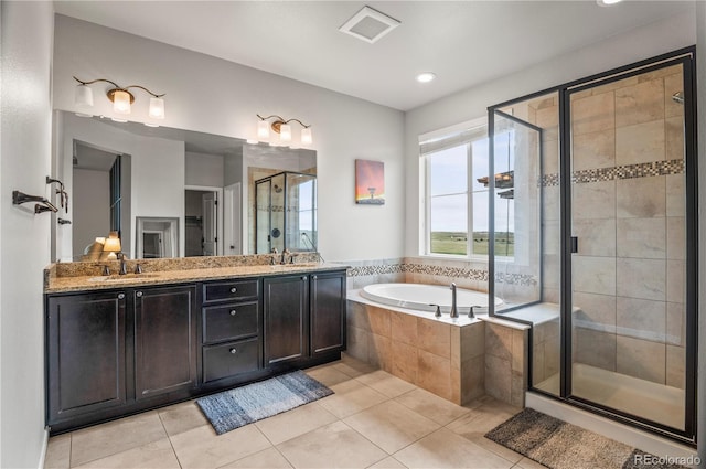 bathroom featuring a sink, a bath, a stall shower, and tile patterned floors