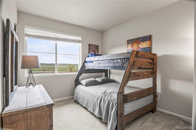 bedroom with carpet floors and baseboards