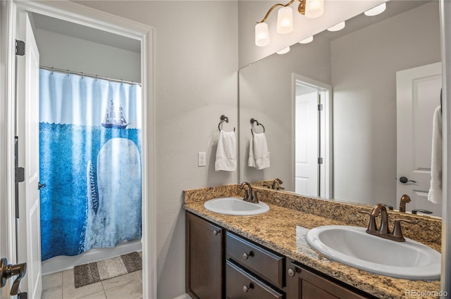 full bathroom featuring double vanity, curtained shower, and a sink