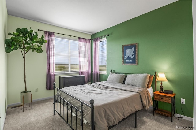 carpeted bedroom featuring baseboards