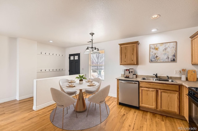 kitchen featuring brown cabinetry, a sink, light wood-style floors, and stainless steel dishwasher