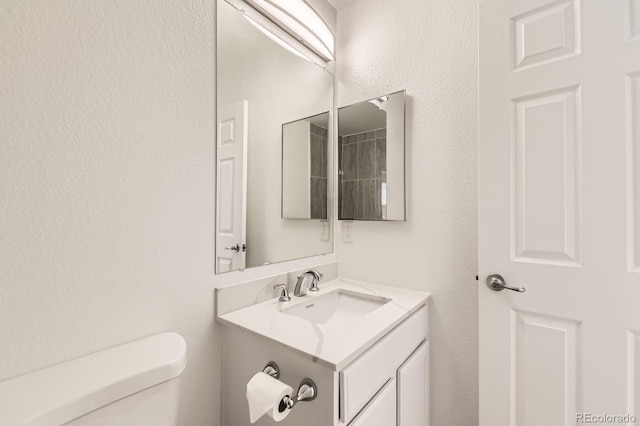 bathroom with toilet and vanity