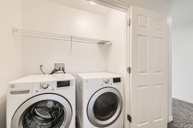 washroom with washing machine and clothes dryer, laundry area, carpet flooring, and baseboards