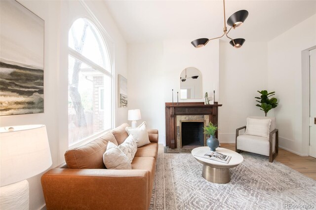 230 E Ellsworth Ave, Denver, CO 80209 - living room with a fireplace with flush hearth, wood finished floors, and baseboards