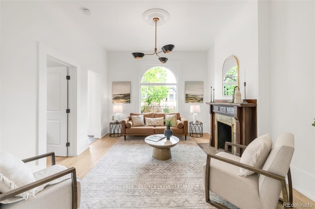 230 E Ellsworth Ave, Denver, CO 80209 - living room with light wood-style floors, a fireplace with flush hearth, and baseboards