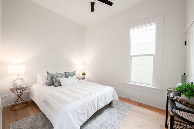 230 E Ellsworth Ave, Denver, CO 80209 - bedroom with multiple windows, light wood-type flooring, baseboards, and ceiling fan