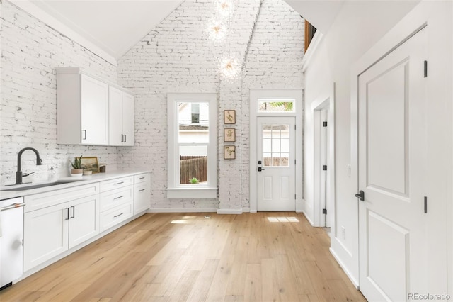 230 E Ellsworth Ave, Denver, CO 80209 - kitchen with a sink, white cabinets, white dishwasher, light countertops, and light wood-type flooring