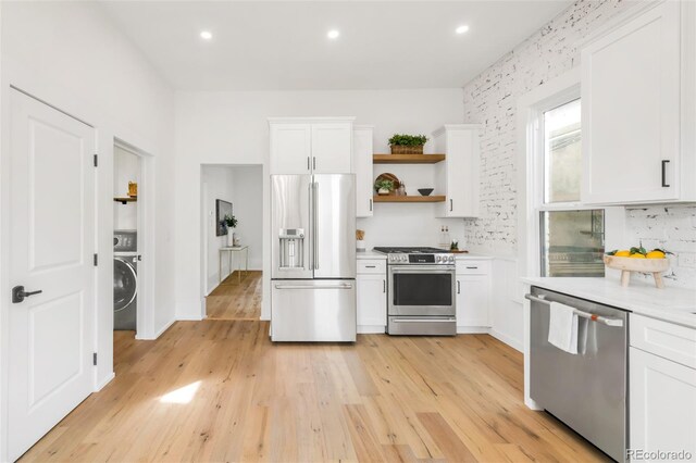 230 E Ellsworth Ave, Denver, CO 80209 - kitchen with stainless steel appliances, light countertops, white cabinetry, open shelves, and light wood finished floors