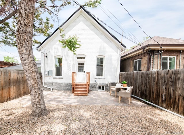 230 E Ellsworth Ave, Denver, CO 80209 - rear view of property featuring brick siding, entry steps, a patio, and a fenced backyard