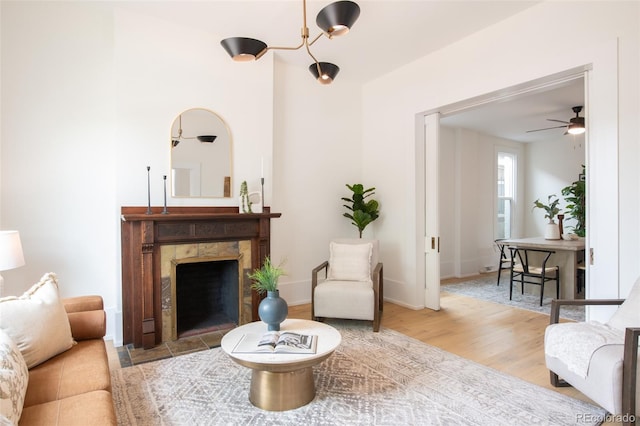 230 E Ellsworth Ave, Denver, CO 80209 - living area with a premium fireplace, wood finished floors, ceiling fan, and baseboards