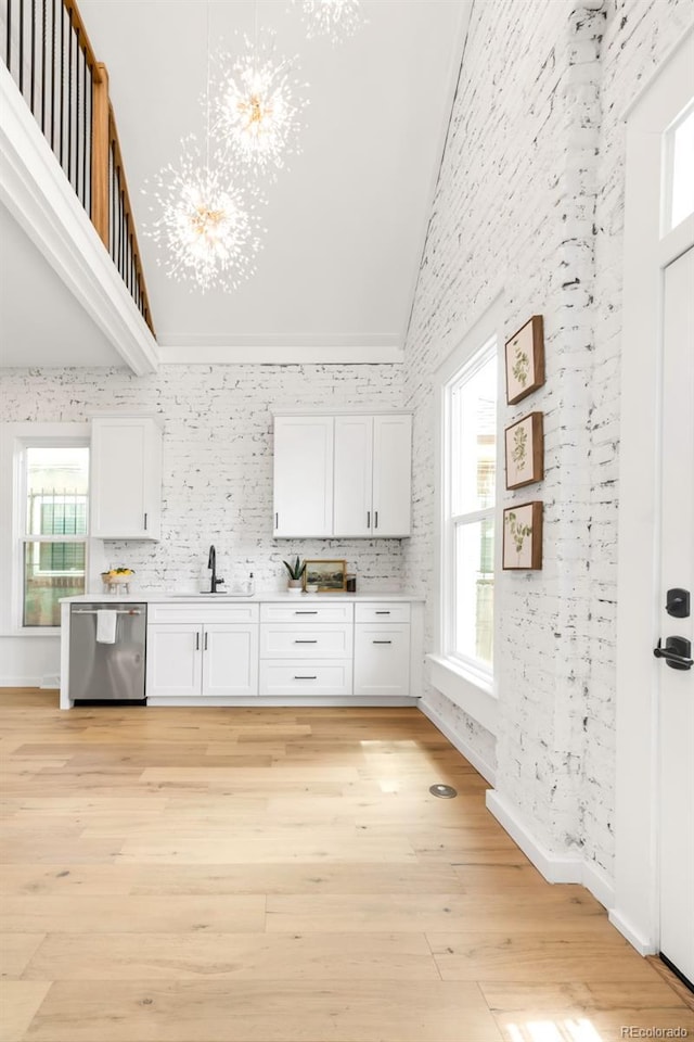 230 E Ellsworth Ave, Denver, CO 80209 - kitchen featuring dishwasher, a sink, white cabinetry, a chandelier, and light countertops