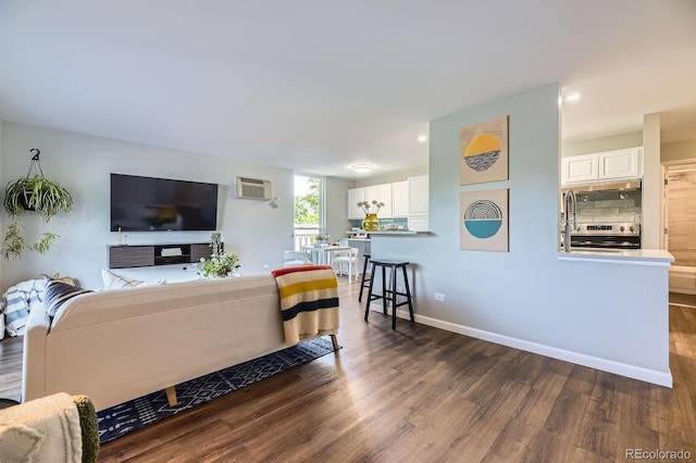 937 N Clarkson St Unit 405, Denver, CO 80218 - living area with dark wood-type flooring, a wall mounted air conditioner, and recessed lighting