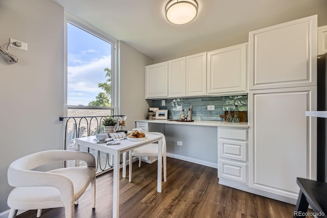 937 N Clarkson St Unit 405, Denver, CO 80218 - kitchen with backsplash, dark wood finished floors, white cabinetry, light countertops, and a desk