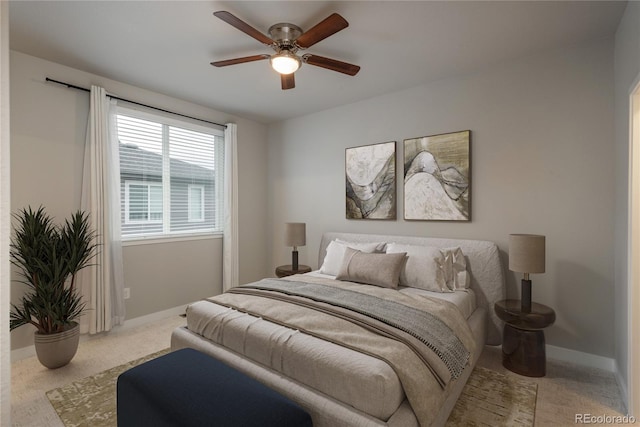 bedroom featuring ceiling fan and light carpet