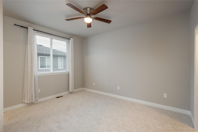 spare room with light carpet and ceiling fan