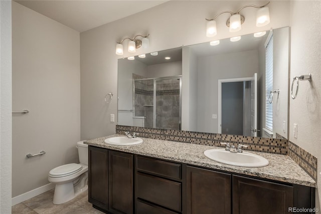 bathroom featuring vanity, decorative backsplash, a shower with shower door, tile patterned floors, and toilet