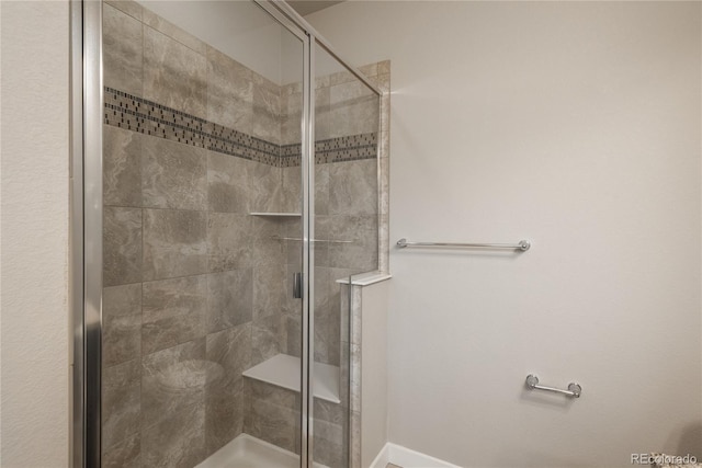 bathroom with a shower with door