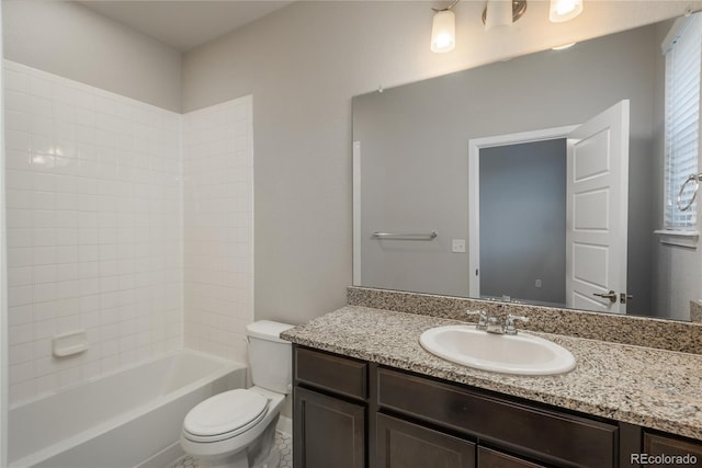 full bathroom with vanity, tiled shower / bath combo, and toilet