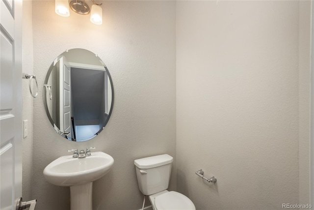 bathroom featuring toilet and sink