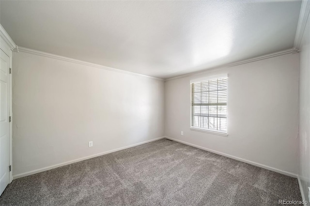 carpeted spare room featuring ornamental molding and baseboards