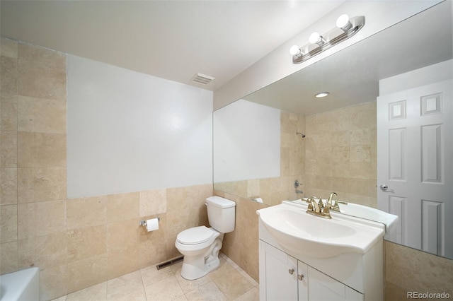 full bath featuring tile walls, tile patterned flooring, a shower, toilet, and vanity