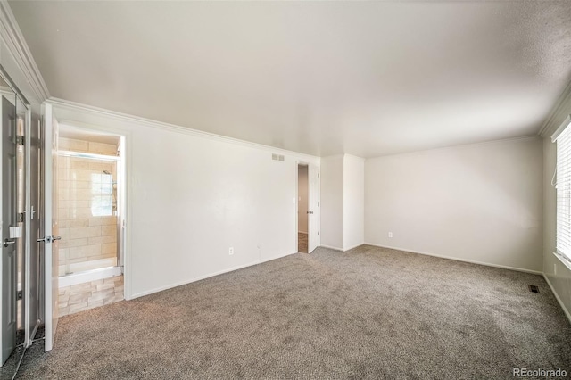 carpeted empty room featuring ornamental molding and baseboards