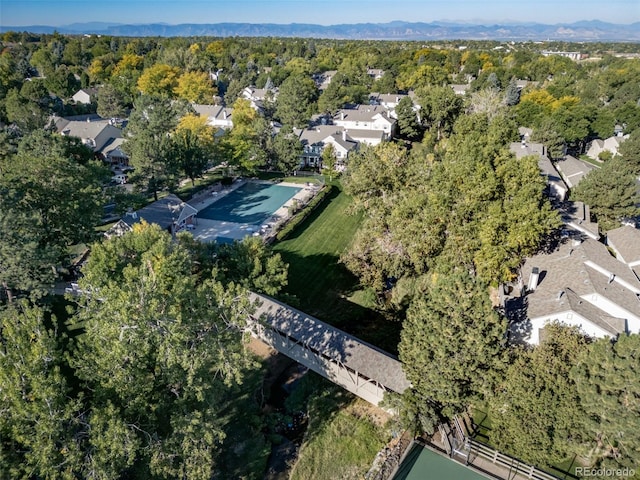 aerial view of property and surrounding area featuring a forest