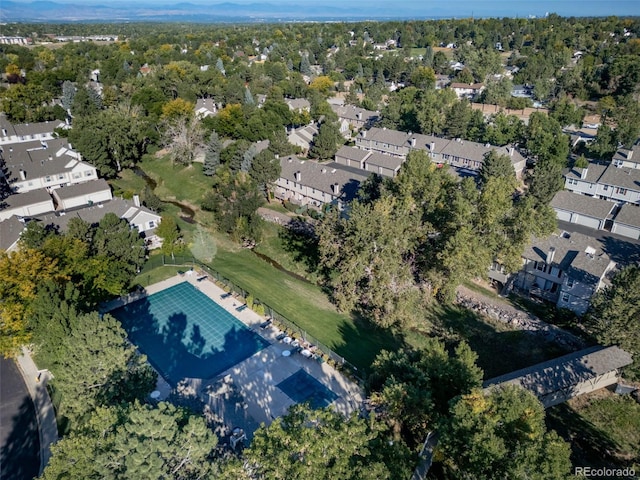 aerial view of property and surrounding area featuring nearby suburban area