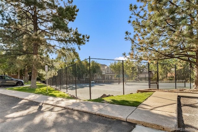 view of tennis court featuring fence