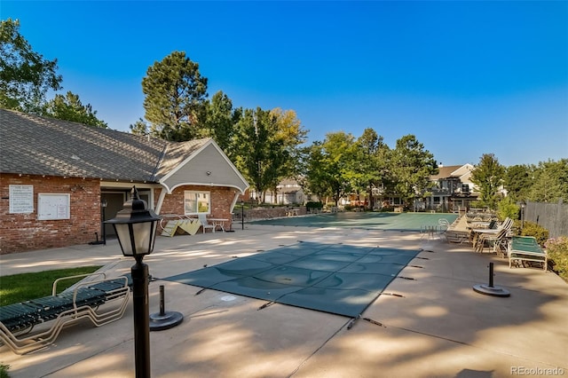 community pool featuring a patio and fence