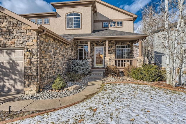 view of front of property featuring covered porch and a garage