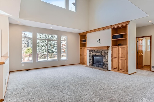 unfurnished living room featuring a fireplace and light carpet