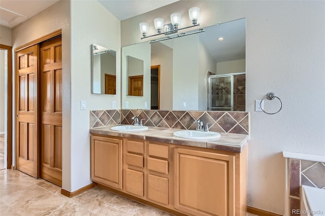 bathroom featuring tasteful backsplash, vanity, and walk in shower