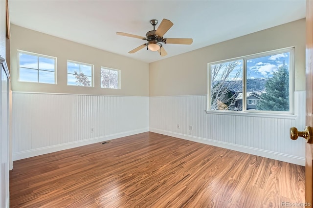 empty room featuring ceiling fan and wood-type flooring