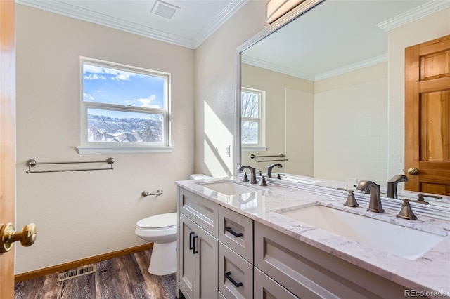 bathroom featuring hardwood / wood-style floors, vanity, toilet, and crown molding