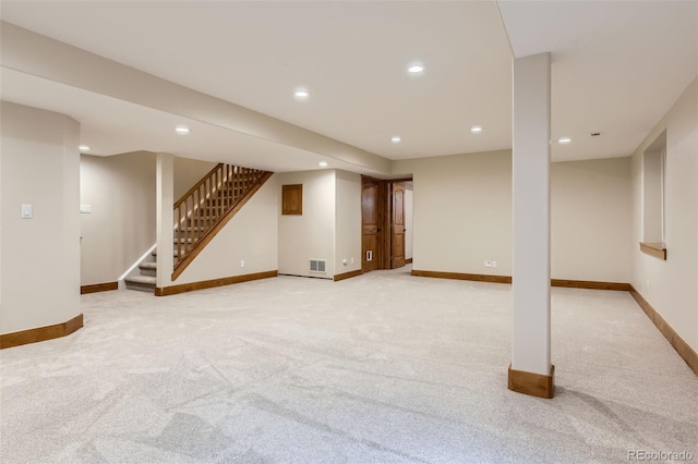 basement featuring light colored carpet