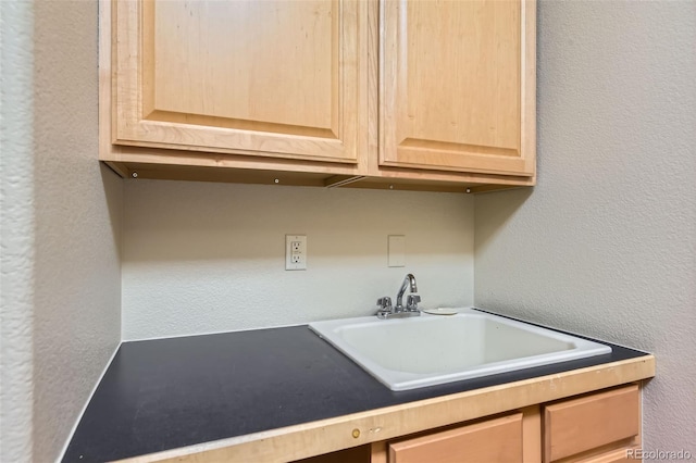 kitchen featuring light brown cabinets and sink