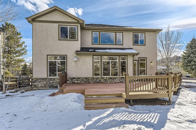 snow covered property featuring a deck